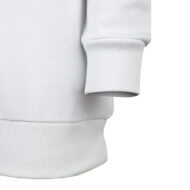 Close-up of a white sweatshirt showing a ribbed cuff and bottom hem.