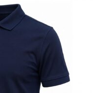 Close-up of a navy polo shirt's collar, shoulder, and short sleeve on a white background.