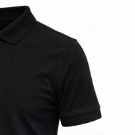 Close-up of a black polo shirt shoulder and sleeve with a standard collar edge visible on a white background.