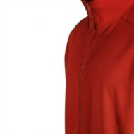 Close-up of a red perforated athletic jacket with a short zipper at the collar and visible seam lines