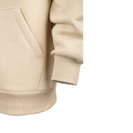 Close-up of a beige hoodie sleeve with ribbed cuff and front pocket detail.