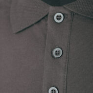 Close-up of a dark brown polo shirt showing a buttoned placket with two gray buttons and textured fabric