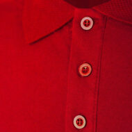 Close-up of red fabric with a vertical row of cream-colored, four-hole buttons on a placket