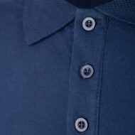 Close-up of a navy polo shirt collar with a button placket and four dark buttons visible in a neat row