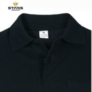 Close-up of a black polo shirt collar with a size tag reading M and 100% PAMUK; Staris Workwear logo top-left.