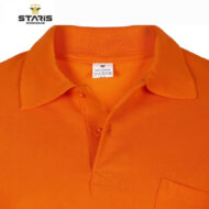 Close-up of a bright orange polo shirt collar with button placket and a visible size tag (M, 100% cotton).