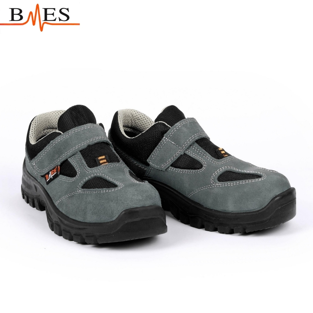Pair of gray and black kids' sneakers with Velcro straps on a white background, BMES logo above left.
