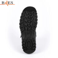 Bottom view of a black boot sole with aggressive, multidirectional tread and circular heel grip; BMES logo appears in the top-left corner.