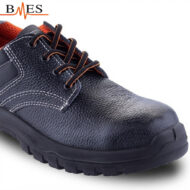 Close-up of a dark blue leather safety shoe with orange laces and a rugged sole; brand BMES visible at top-left.