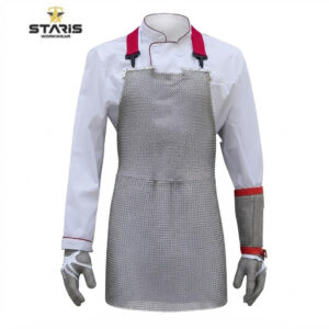 Chainmail protective apron worn over a white chef jacket with red straps for kitchen safety (Staris Workwear).