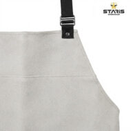 Beige textured work apron with a black strap and metal buckle, stitching visible, logo in the top-right corner reading STARIS WORKWEAR (partial).