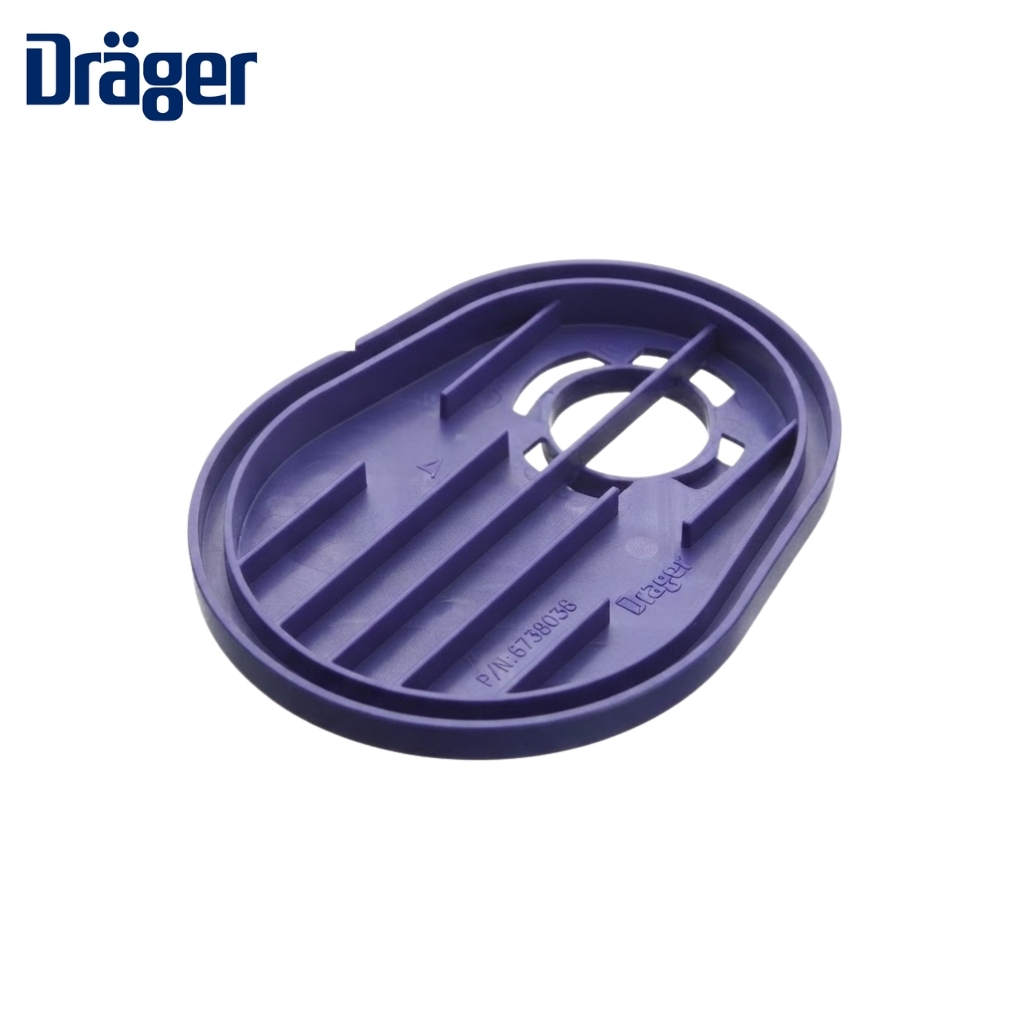 Purple oval plastic component with interior ribs and a circular hole; Dräger logo visible in the corner.