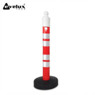 Red-and-white reflective safety delineator post standing on a round black base, used to mark hazards or guide traffic.
