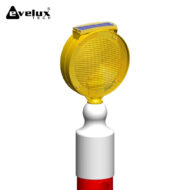 Yellow circular warning beacon with a solar panel on top, mounted on a white pole with a red base.