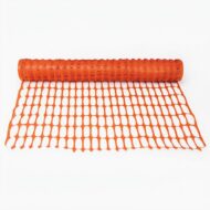 Roll of orange construction safety mesh fencing, partially unrolled on a white background.