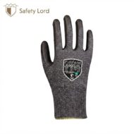 Close-up of a gray textured safety glove with a black shield label on the back, displayed against a white background.
