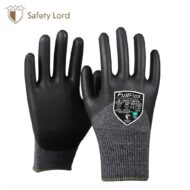 Pair of black safety gloves with textured palms and gray knit cuffs on a white background.