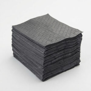 Stack of dark gray perforated napkins neatly piled on a white surface.