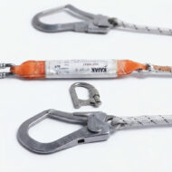 Climbing gear with metal carabiners and an orange harness strap laid out on a white surface, ready for use.