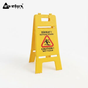 Yellow portable caution sign with 'Dikkat! Kaygan Zemin' and 'Caution! Wet Floor' text, Evelux Tech logo in corner.