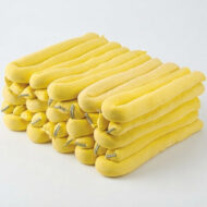 Stack of yellow foam hair rollers with metal clips for curling hair.