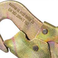 Close-up of multicolored locking pliers (yellow-green coating) showing printed metal markings on the jaw.