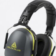 Close-up of Delta Plus over-ear gaming headset with lime-green accents and cushioned headband.