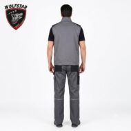 Back view of a man in gray workwear: sleeveless vest over a black shirt and gray cargo pants, standing on a white studio background with a Wolfstar logo top-left.