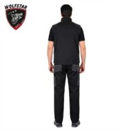 Person wearing a black polo and cargo pants shown from the back, logoed brand Wolstar top-left.