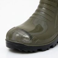 Close-up of an olive-green rubber boot toe with a visible steel-toe insert window and rugged black sole.