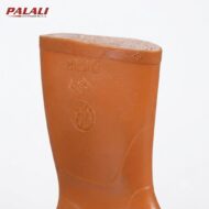 Brown rubber boot standing upright against a white background, with embossed logos on the shaft.