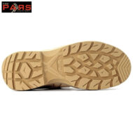 Beige rugged rubber outsole with aggressive multi-directional lugs for traction; brand logo visible in the top-left corner.