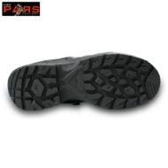 Bottom view of a black rugged hiking boot sole with deep angular tread patterns for traction.