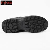 Bottom view of a black hiking boot sole with deep, aggressive tread lugs for traction; center shows subtle branding.