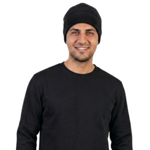 Smiling man in a black beanie and black long-sleeve shirt, facing the camera against a white background.