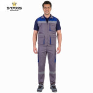 Man wearing a grey and blue Staris workwear vest with multiple pockets, standing against a white background.