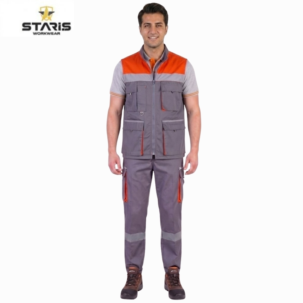 Man wearing Staris workwear: grey utility vest with orange shoulder panels and multiple pockets, matching grey pants with orange zippers and reflective leg stripes, standing against a white background with a Staris logo in the corner.