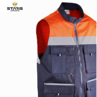 Orange-and-navy high-visibility work vest with a reflective gray stripe, multiple front pockets, and a front zipper; brand STARIS visible in the corner.