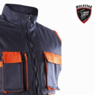 Navy outdoor jacket with orange pocket flaps and zippers, zip-up front and high collar; Wolfstar logo in the upper right corner.