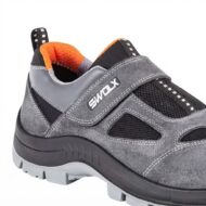 Gray and black athletic sneaker with orange inner lining and a Velcro strap labeled SWOLX, close-up of the side and sole