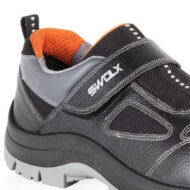 Close-up of a black and gray athletic sneaker with an orange interior and a Velcro strap labeled SWOX.