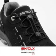 Black SWOLX safety shoe close-up showing lace toggle, eyelets, and perforated suede panel with branding on the tongue.