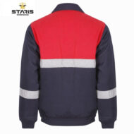 Back view of a color-blocked work jacket: red upper panel, navy lower body, with silver reflective bands on chest and sleeves.