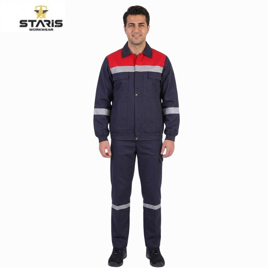 Man modeling a navy blue safety jumpsuit with a red chest panel and reflective stripes on the sleeves and legs, Staris Workwear logo visible in the top left.