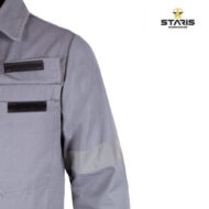 Gray industrial work jacket with two Velcro-flap chest pockets and a reflective sleeve stripe, Staris Workwear logo in the corner