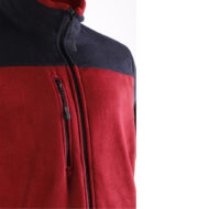 Close-up of a red and navy fleece jacket with a standing collar and zippered pockets visible on the front.