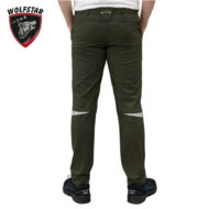 Back view of olive-green pants with zippered rear pocket and reflective striped panels at the knees; Wolfstar logo visible on waistband, person wearing dark sneakers.